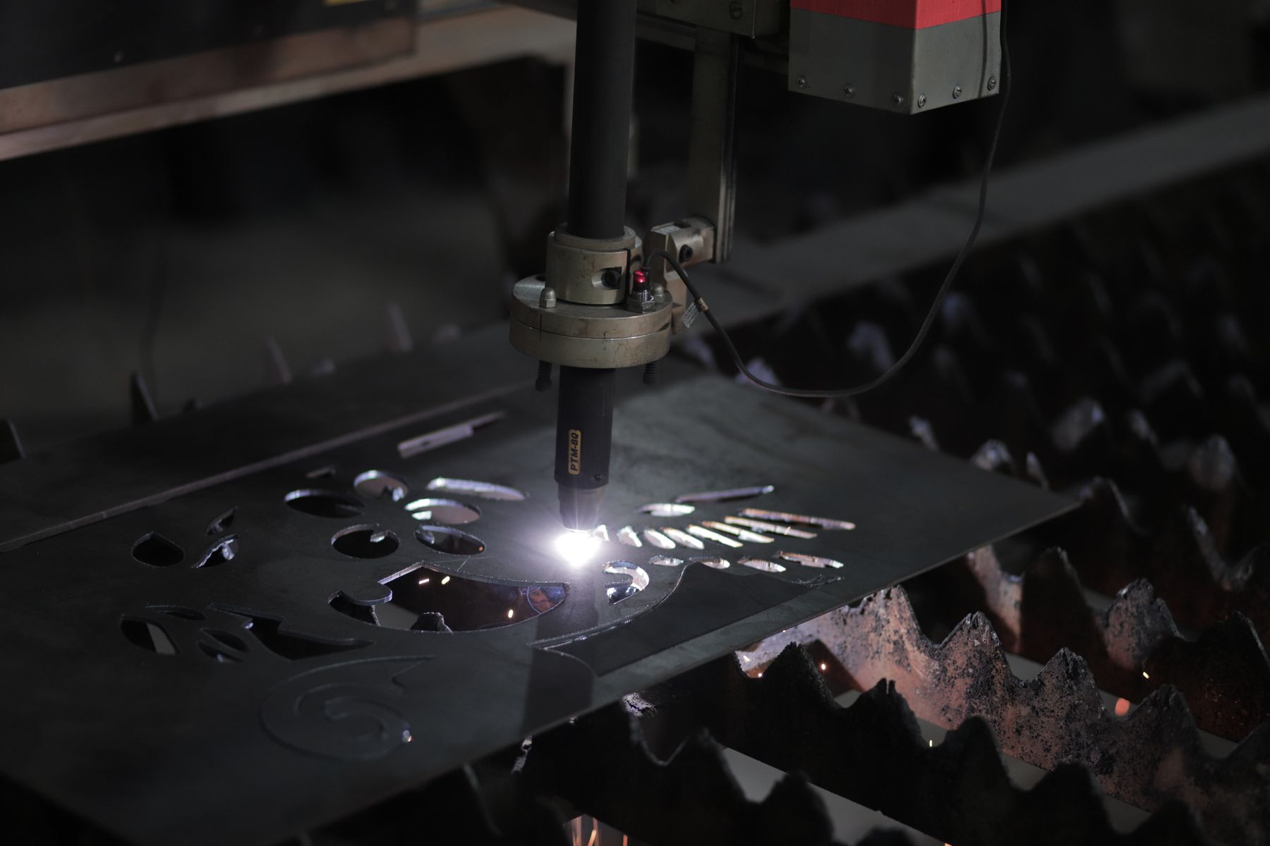 Thermal beam cutting precision parts from a metal sheet
